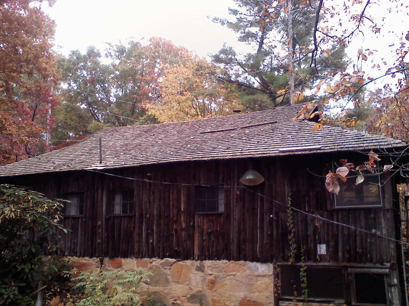 Weathered wood shake roof on a rustic board sided cabin in Hartsel